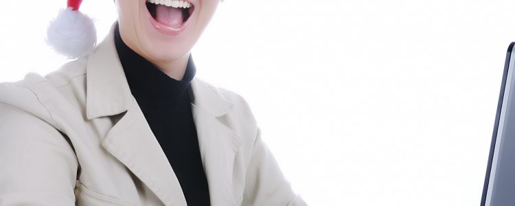 Beautiful business woman is working in office in santa claus hat