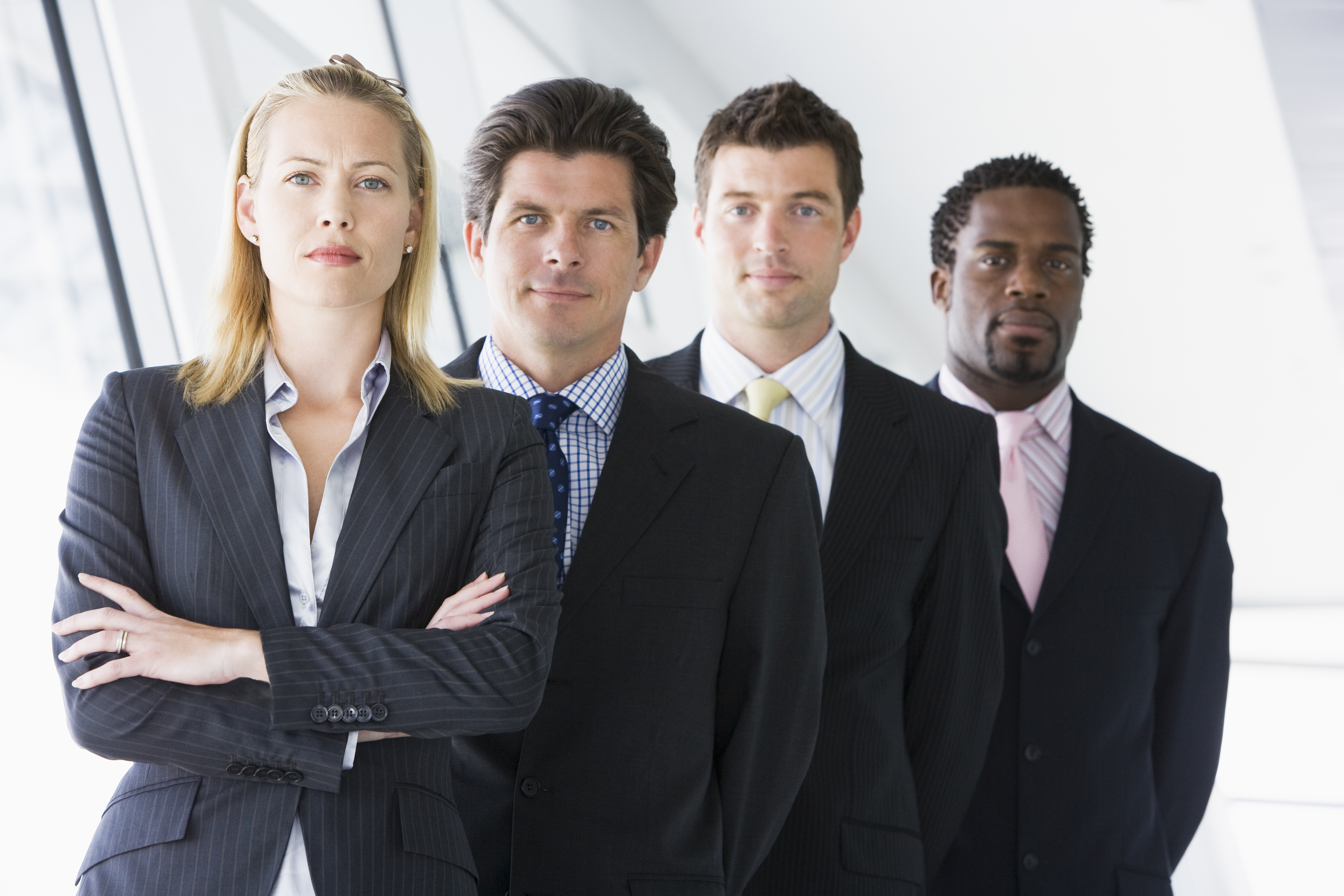 Four businesspeople standing in corridor