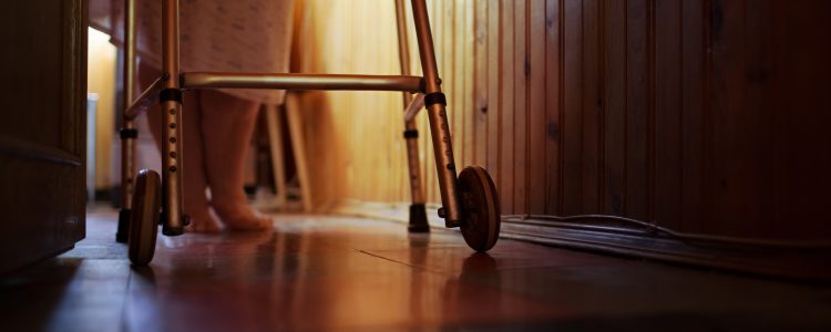 Senior woman using walker at home