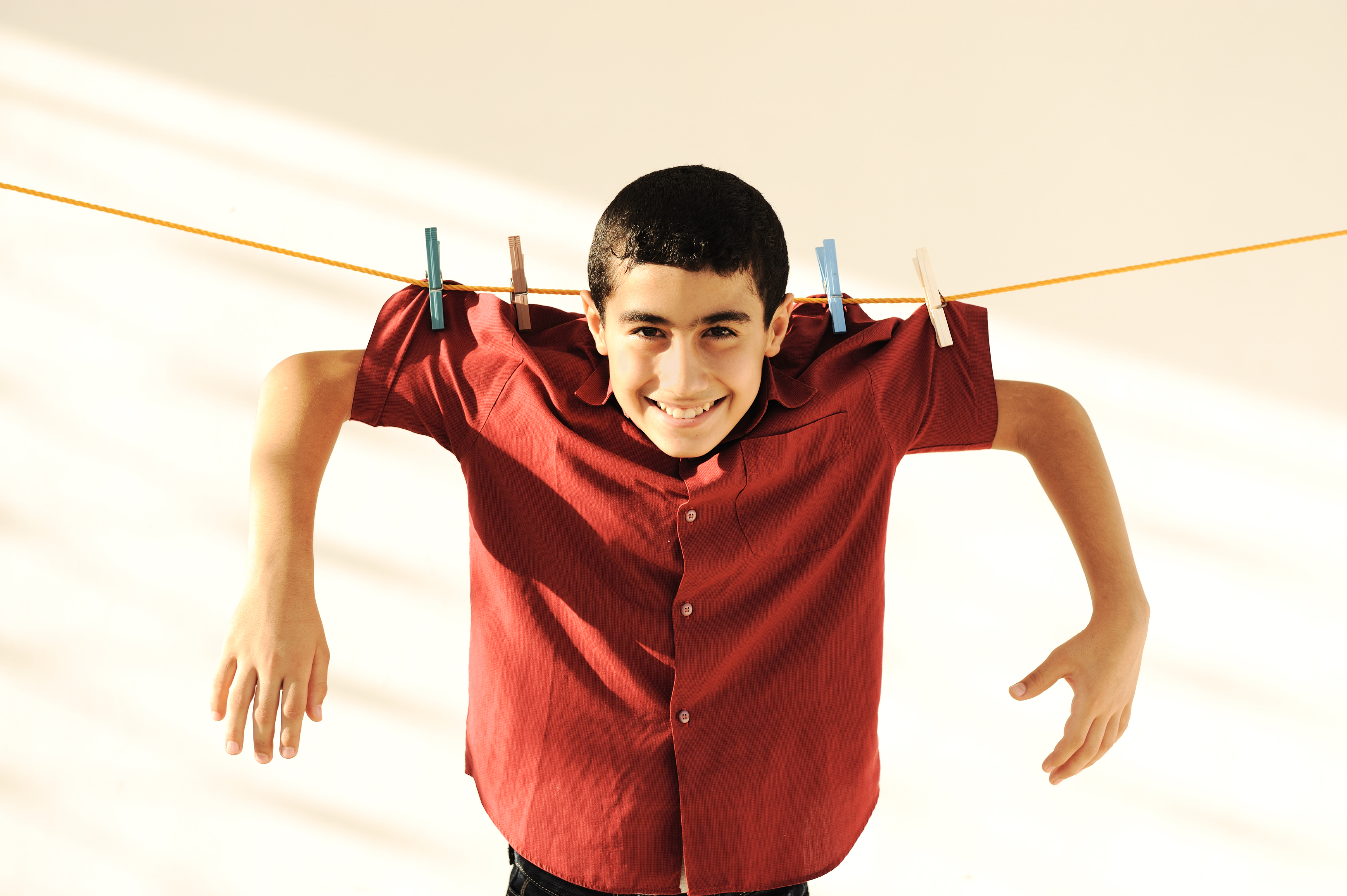 Young kid hanging on a clothesline