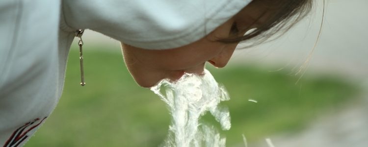 Little girl drinking water from fountain