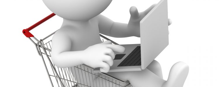 Man with laptop inside shopping cart. Online shopping concept.