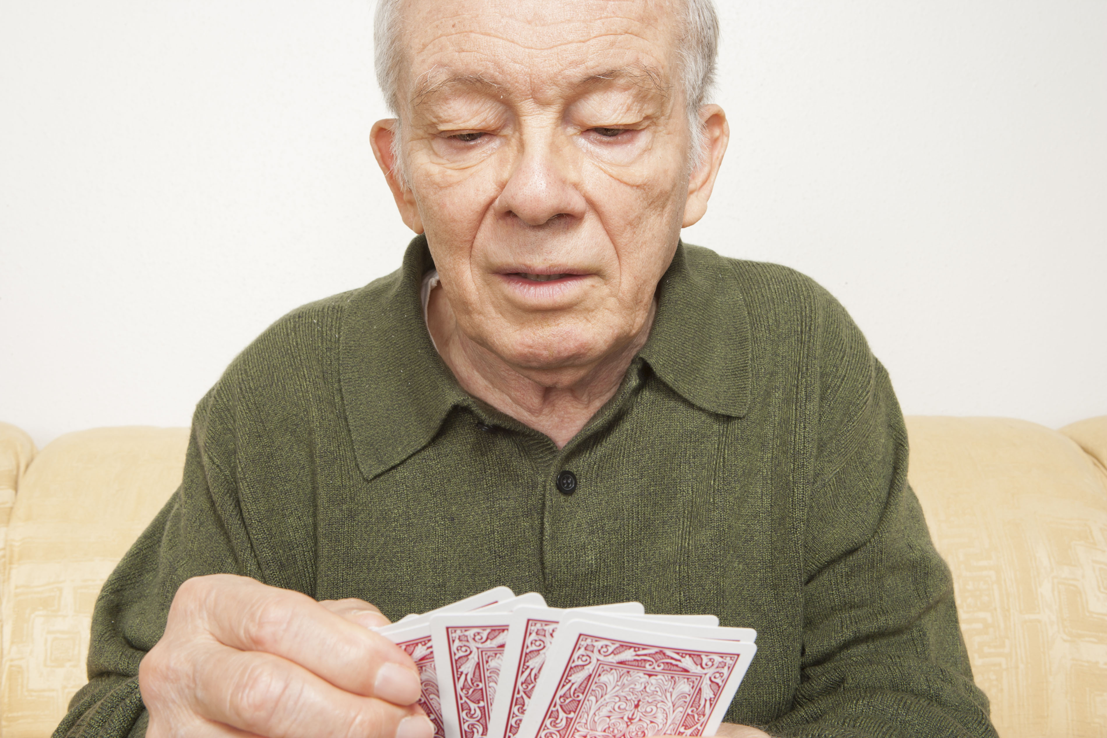 Senior man playing cards