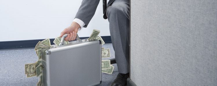 Businessman with briefcase of money
