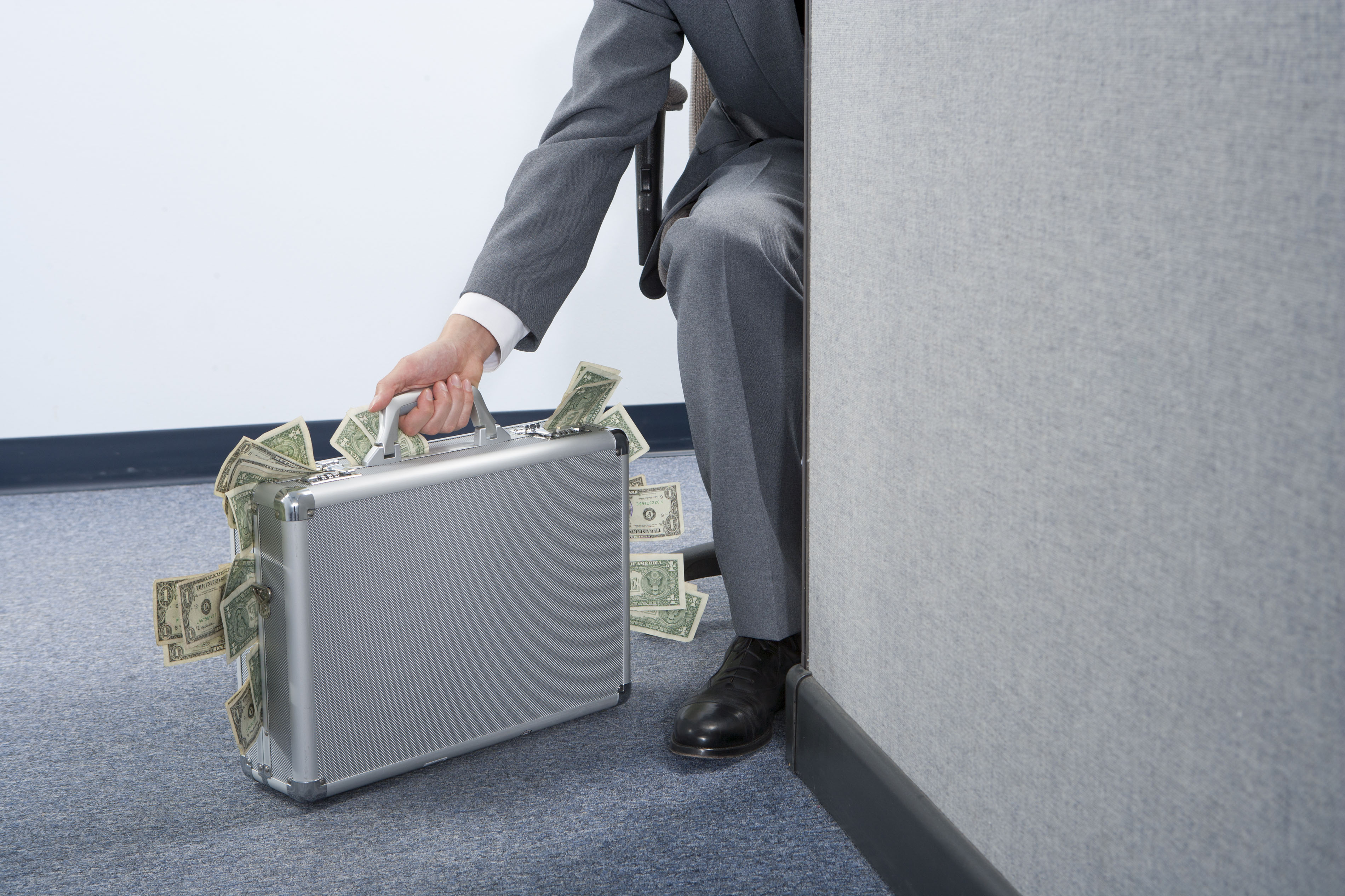 Businessman with briefcase of money