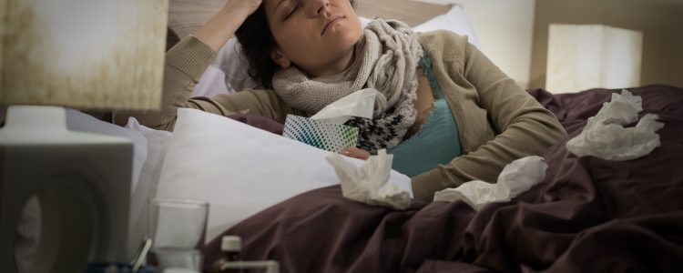 Sick woman in bed suffering flu headache